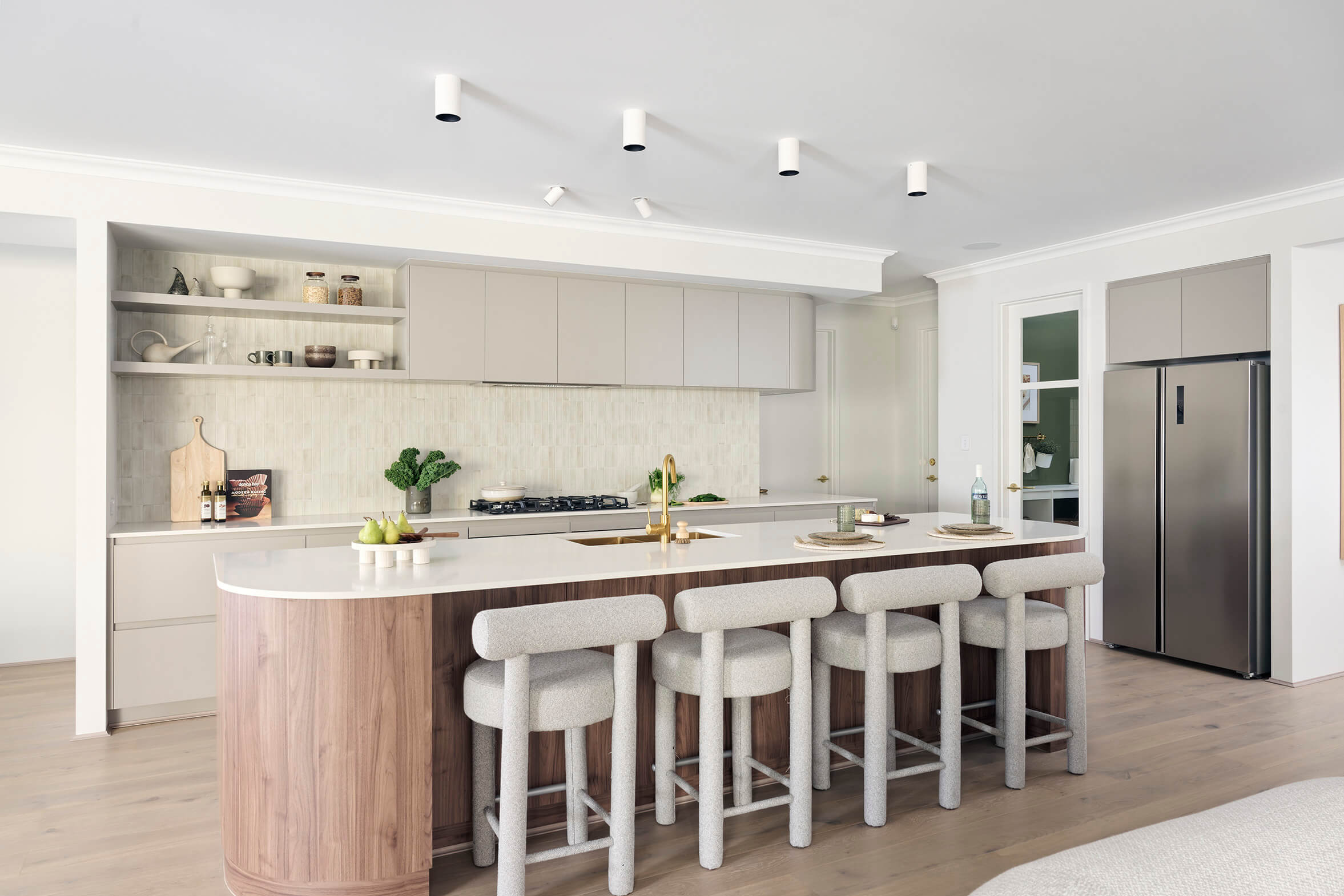 Contemporary Kitchen with a Long Curved Timber Island Bench