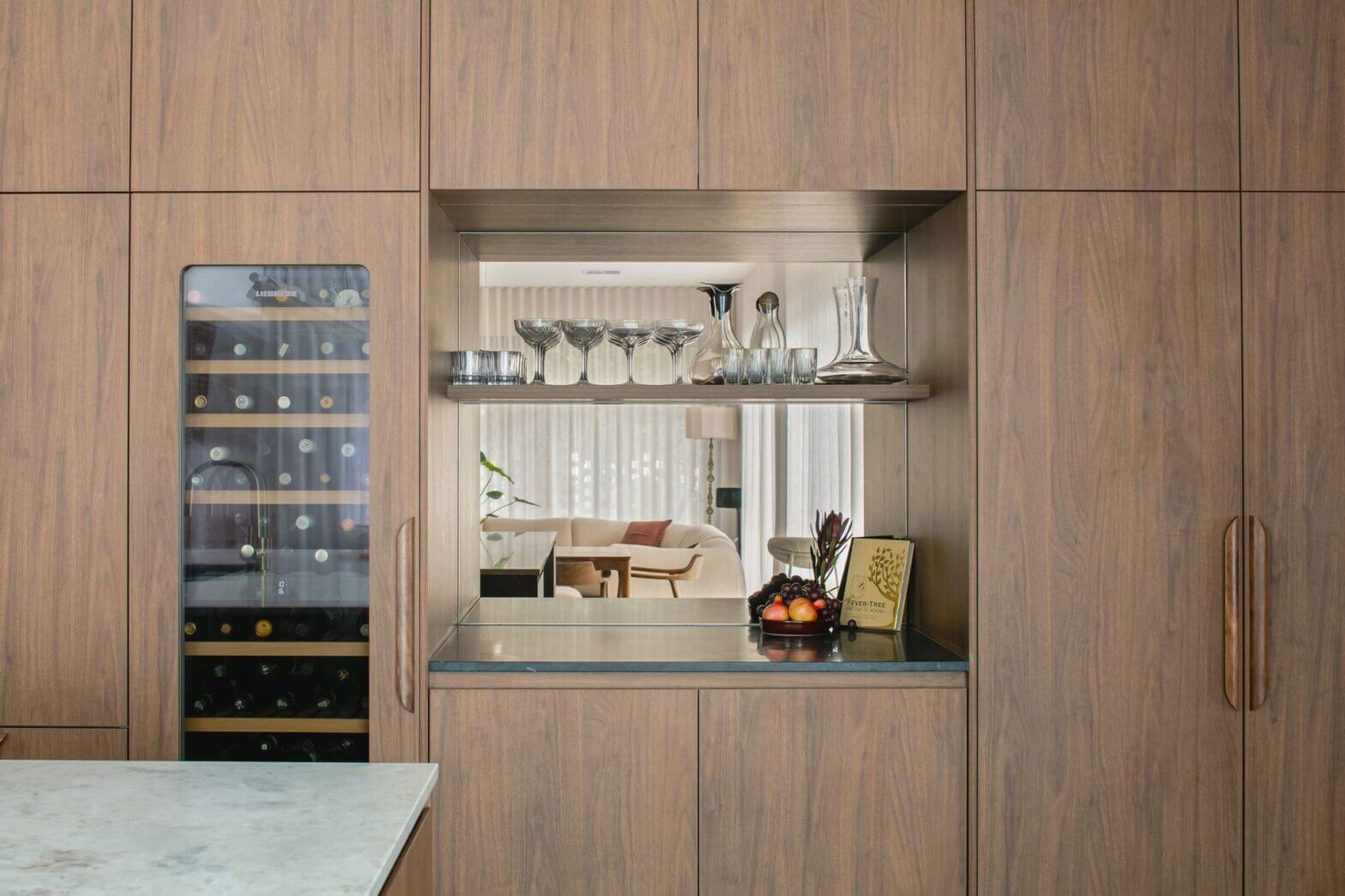 Custom timber cabinetry with built-in wine fridge and open display shelving